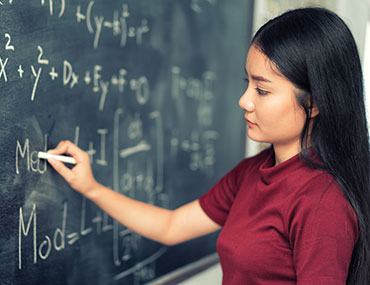 girl writing on chalkboard