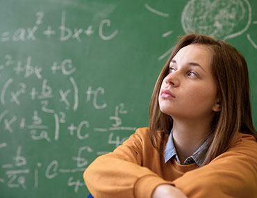 girl writing on chalkboard